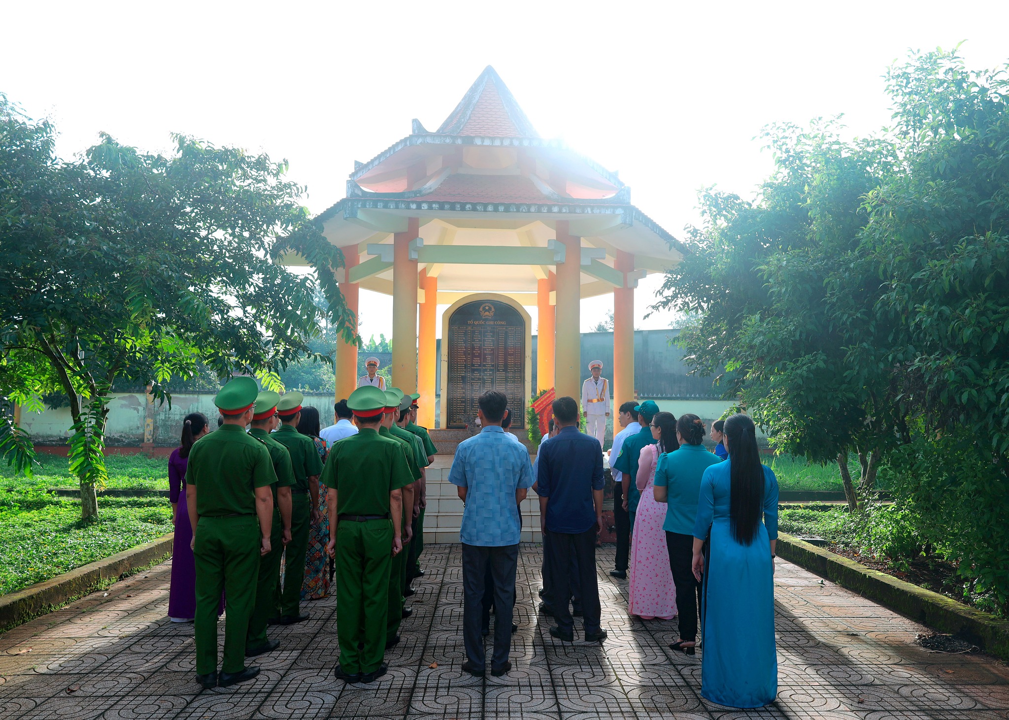 ''A group of people standing in a line outside a building

Description automatically generated''