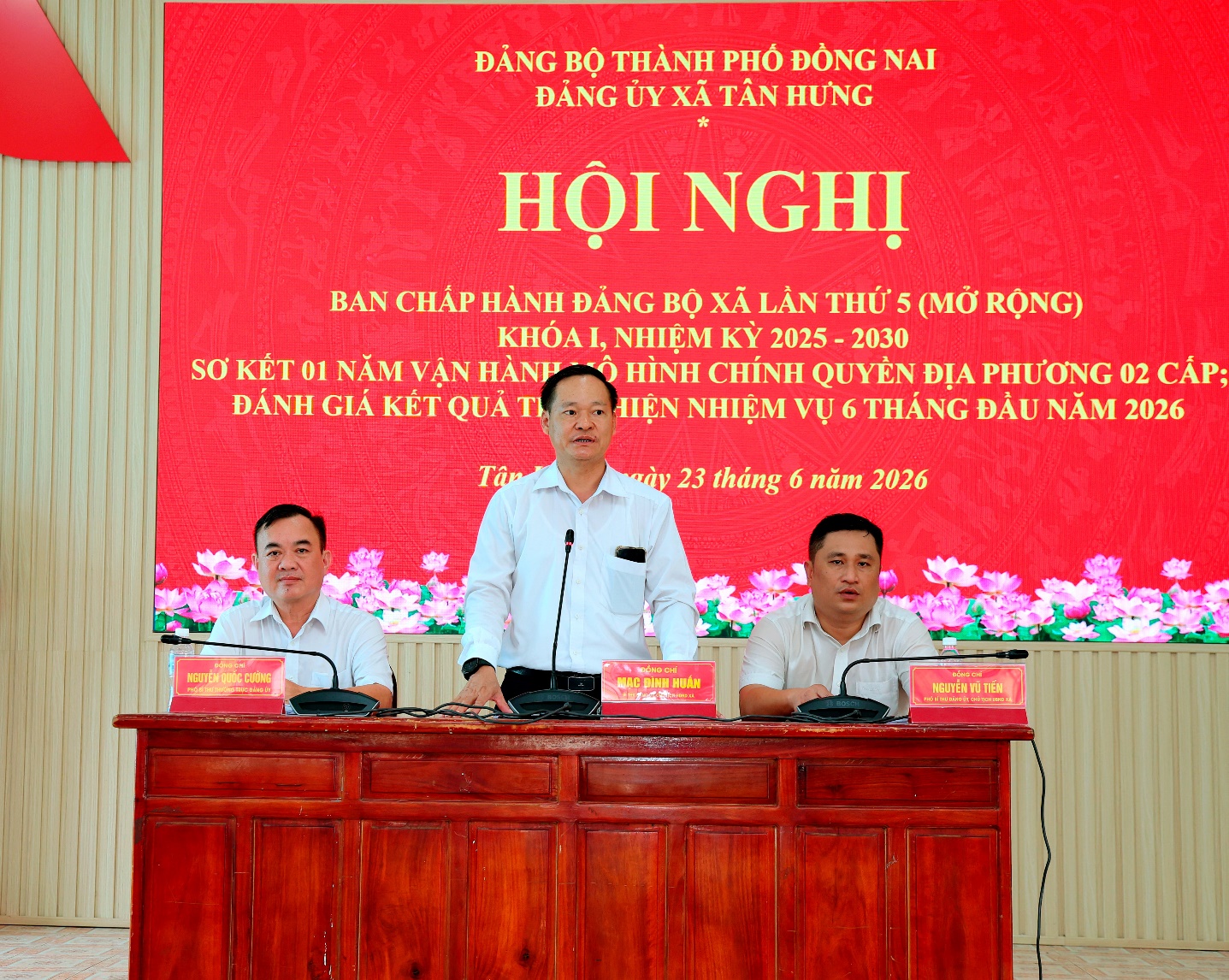 'A group of men standing at a podium

Description automatically generated'