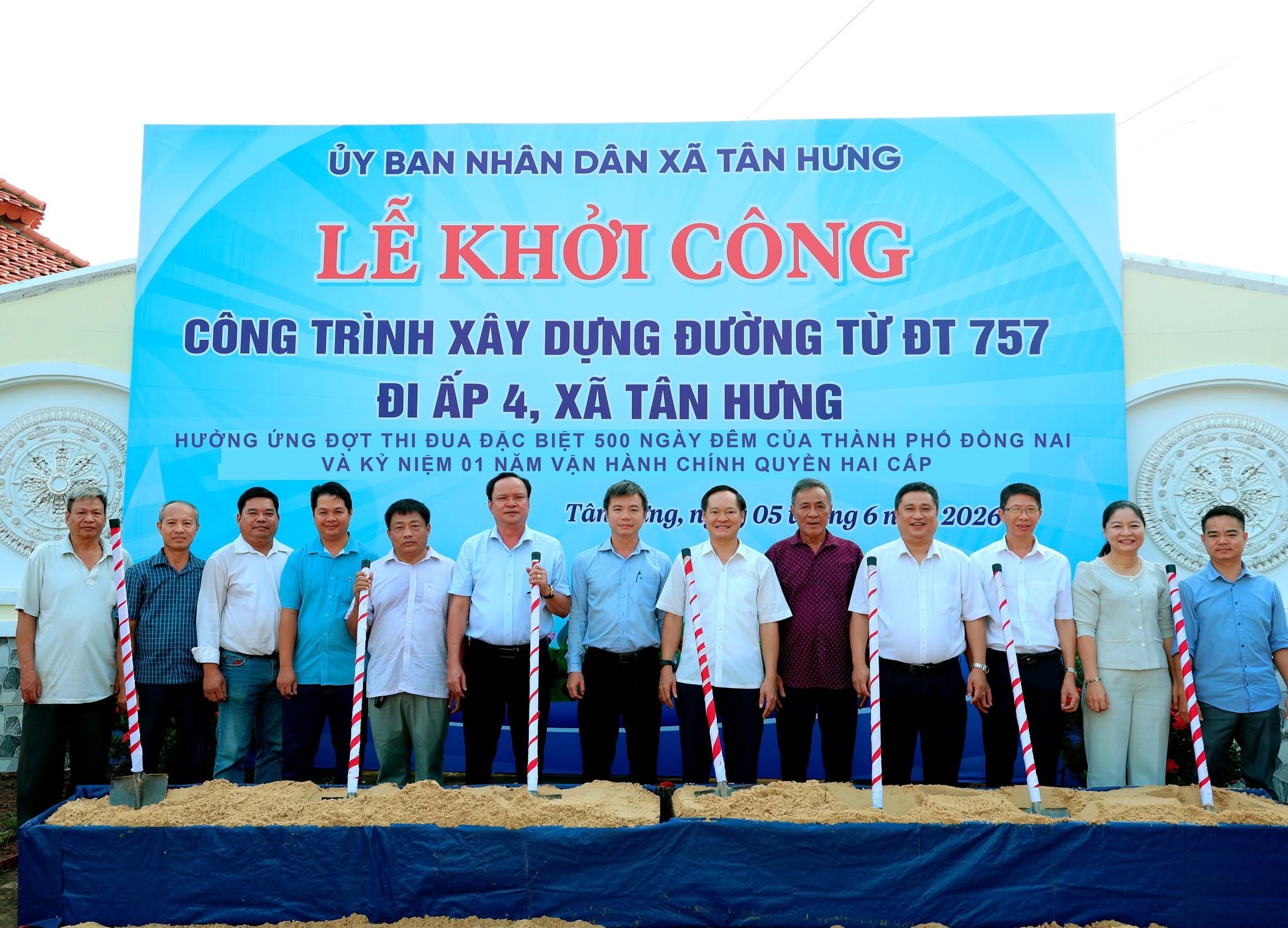 'A group of people standing in front of a banner

Description automatically generated'