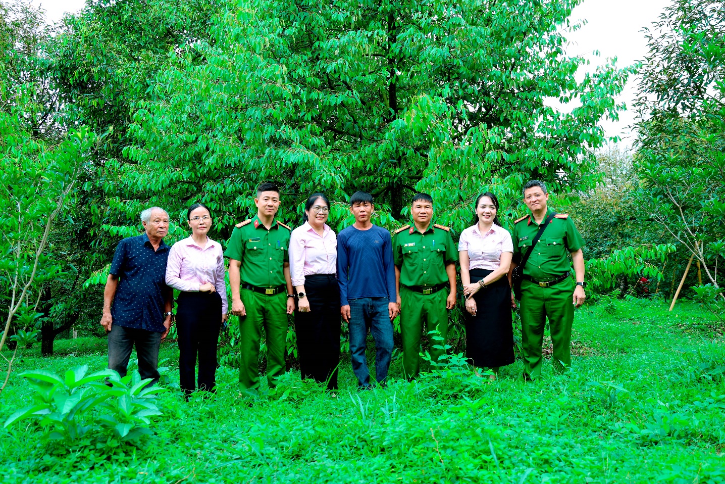 ''A group of people standing in a field

Description automatically generated''