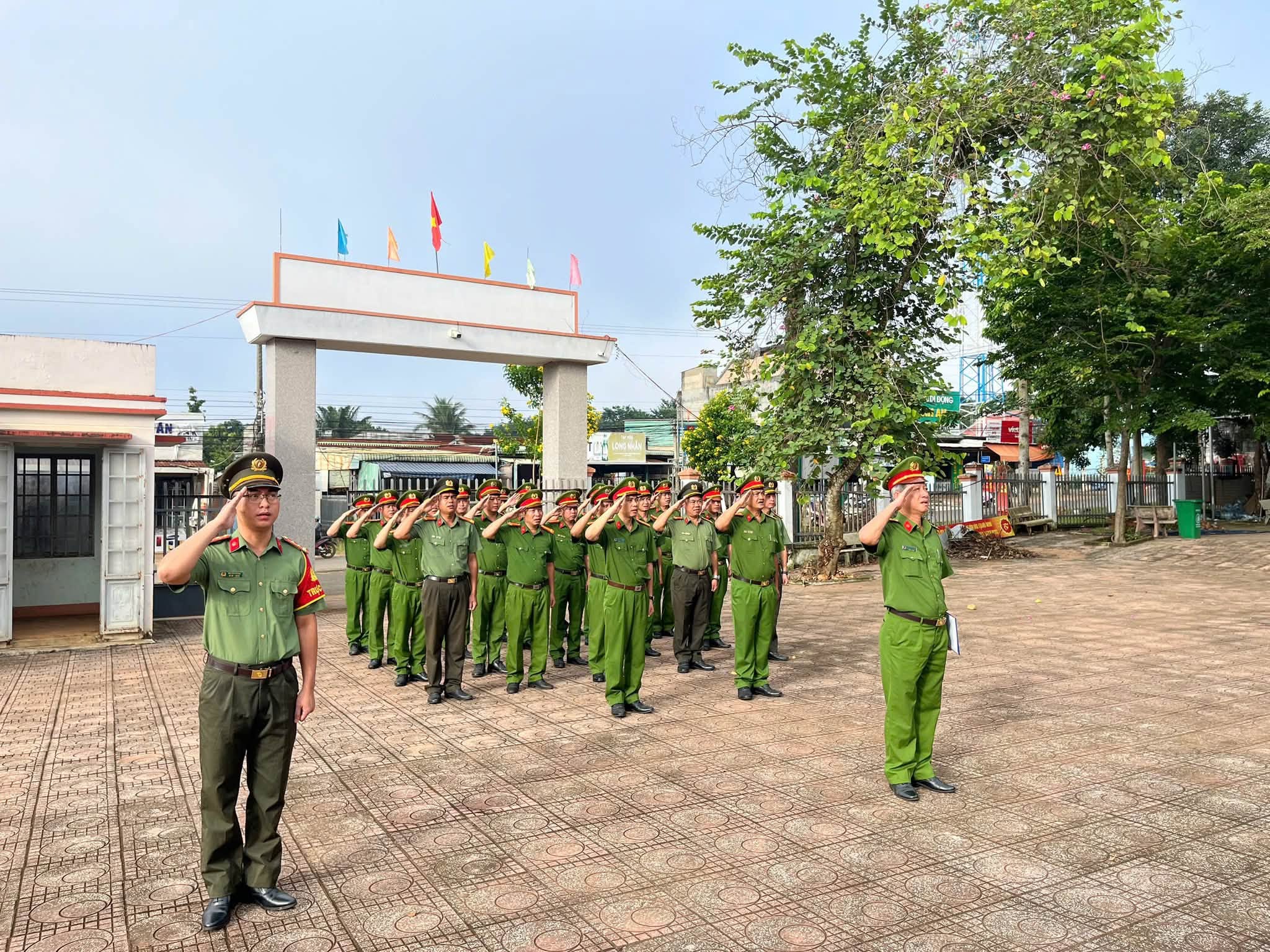 'A group of people in uniform saluting

Description automatically generated'
