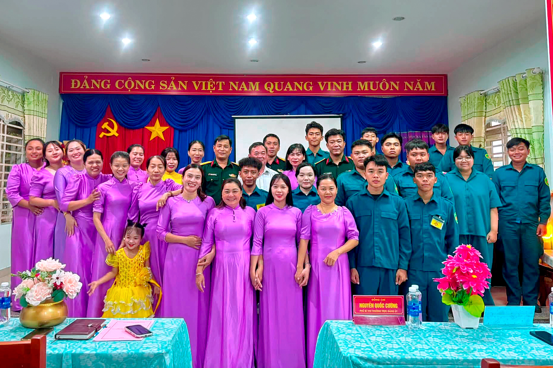 A group of people posing for a photo

Description automatically generated