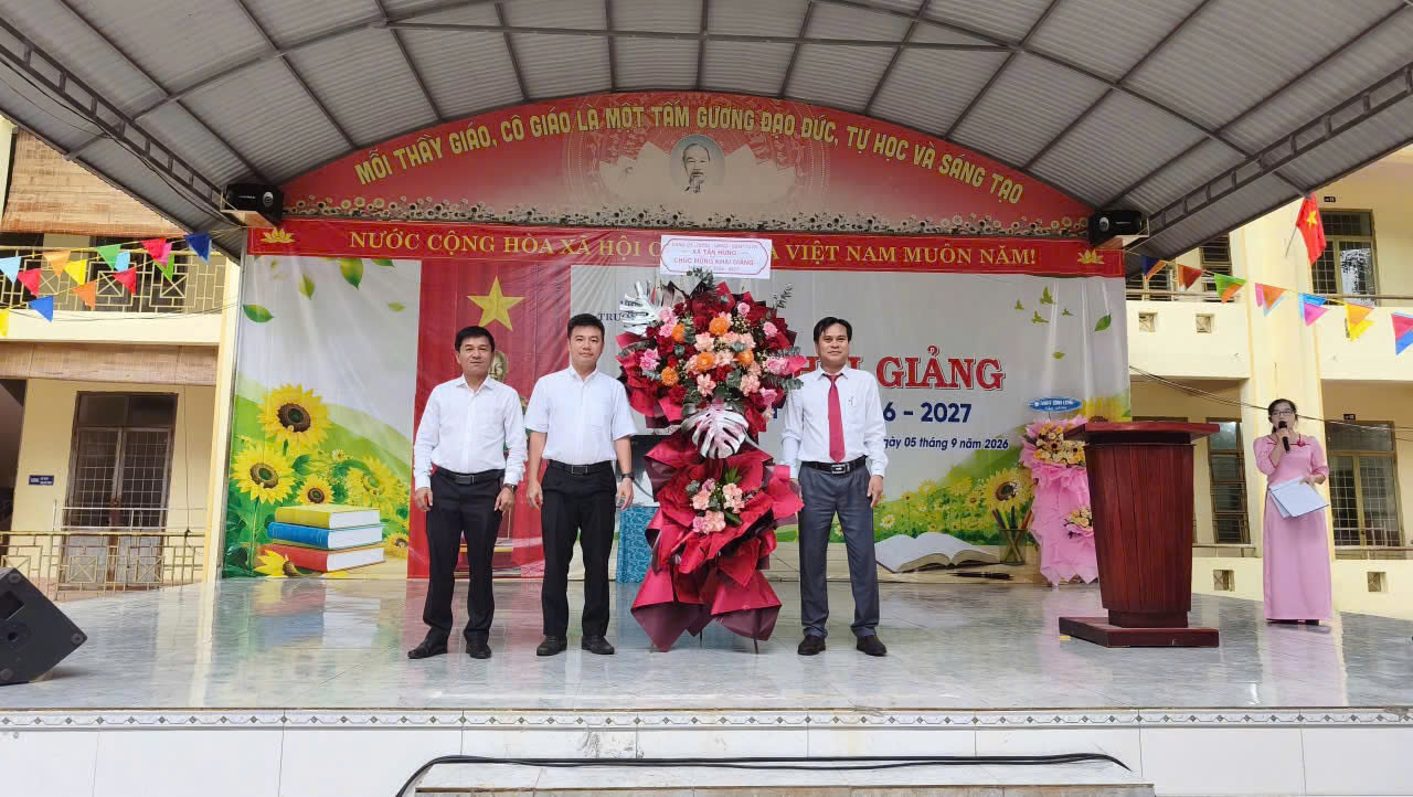 A group of men standing on a stage

Description automatically generated